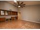 Home office with wood cabinets and tile flooring at 14731 W Trading Post Dr, Sun City West, AZ 85375