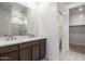 Modern bathroom with double vanity and walk-in shower at 15382 W Hackamore Dr, Surprise, AZ 85387