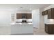 Modern kitchen with island and dark brown cabinets at 15382 W Hackamore Dr, Surprise, AZ 85387