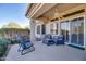 Relaxing patio with seating area, ceiling fan, and sliding glass doors at 16148 W Sentinel Dr, Sun City West, AZ 85375