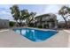 Community swimming pool with surrounding lounge chairs and trees at 16807 E Gunsight Dr # B23, Fountain Hills, AZ 85268