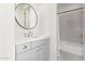 Simple bathroom with gray vanity, shower/tub combo, and patterned tile floor at 17155 W Gracemont St, Surprise, AZ 85388