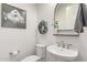 Small bathroom with white sink, toilet and decorative mirror at 17155 W Gracemont St, Surprise, AZ 85388