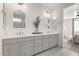 Elegant bathroom with double vanity, gray cabinets, and patterned floor tile at 17155 W Gracemont St, Surprise, AZ 85388