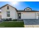 White farmhouse exterior with landscaping, driveway, and two-car garage at 17155 W Gracemont St, Surprise, AZ 85388