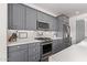 Modern kitchen with stainless steel appliances and gray cabinets at 17155 W Gracemont St, Surprise, AZ 85388