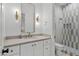 Modern bathroom with white cabinets, quartz countertops, and a large walk-in shower at 17708 N 92Nd St, Scottsdale, AZ 85255