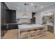 Modern kitchen featuring a large island, dark cabinetry, and high-end appliances at 17708 N 92Nd St, Scottsdale, AZ 85255