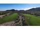 Aerial view of golf course with mountain backdrop at 20090 W Badgett Ln, Litchfield Park, AZ 85340