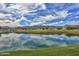 Scenic lake view with golf course and mountain backdrop at 20090 W Badgett Ln, Litchfield Park, AZ 85340