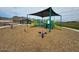 Modern playground with shaded structure and play equipment at 20090 W Badgett Ln, Litchfield Park, AZ 85340