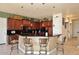 Spacious kitchen with island, dark wood cabinets, and granite countertops at 2105 E Kerry Ln, Phoenix, AZ 85024