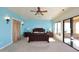 Large main bedroom with light blue walls, walk-in closet, and patio access at 2105 E Kerry Ln, Phoenix, AZ 85024