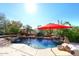 Inviting pool with waterfall features and red umbrella at 2105 E Kerry Ln, Phoenix, AZ 85024