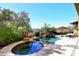 Inviting pool and spa with waterfall feature and red umbrella at 2105 E Kerry Ln, Phoenix, AZ 85024