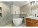 Bathroom boasts a soaking tub, walk-in shower, and modern vanity at 21320 N 56Th St # 1133, Phoenix, AZ 85054