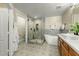 Modern bathroom featuring a walk-in shower, freestanding tub, and dual sinks at 21320 N 56Th St # 1133, Phoenix, AZ 85054