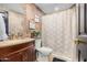 Updated bathroom with stone tile, a shower/tub combo, and new vanity at 22183 N 178Th Ave, Surprise, AZ 85387