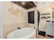 Bathroom with an oval bathtub, shower, and modern fixtures at 22183 N 178Th Ave, Surprise, AZ 85387