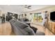 Living room featuring a gray couch, large window, and wood flooring at 22183 N 178Th Ave, Surprise, AZ 85387