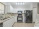 Modern kitchen with granite countertops and black appliances at 2250 E Deer Valley Rd # 48, Phoenix, AZ 85024