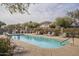 Community swimming pool with lounge chairs and landscaping at 2250 E Deer Valley Rd # 48, Phoenix, AZ 85024