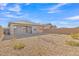 Backyard view of house with gravel and trees at 23120 E Twilight Dr, Queen Creek, AZ 85142