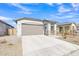 New construction home exterior with a two-car garage and landscaped front yard at 23120 E Twilight Dr, Queen Creek, AZ 85142