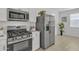 Stainless steel appliances and white cabinets in this modern kitchen at 23120 E Twilight Dr, Queen Creek, AZ 85142