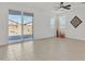 Bright living room with tile floors and sliding glass door to backyard at 23120 E Twilight Dr, Queen Creek, AZ 85142