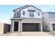 Charming two-story home with a neutral color palette, attached garage, and well-manicured landscaping at 2444 W Rowel Rd, Phoenix, AZ 85085