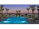 Community pool with lounge chairs and cabanas at sunset at 2444 W Rowel Rd, Phoenix, AZ 85085