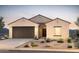 Single-story home with two-car garage and desert landscaping at 25237 W Altanta Ave, Buckeye, AZ 85326