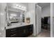 Bathroom with double vanity, walk-in closet, and dark wood cabinets at 2653 E Marcos Dr, Casa Grande, AZ 85194