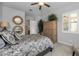 Bedroom with a wooden armoire and large window with plantation shutters at 2653 E Marcos Dr, Casa Grande, AZ 85194