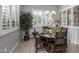 Bright dining room with rustic wooden table and white plantation shutters at 2653 E Marcos Dr, Casa Grande, AZ 85194