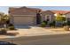 Single-story home with a two-car garage and desert landscaping at 2653 E Marcos Dr, Casa Grande, AZ 85194