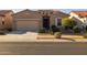 One-story home with tan exterior, two-car garage, and desert landscaping at 2653 E Marcos Dr, Casa Grande, AZ 85194