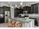 Modern kitchen with dark cabinets, granite countertops and an island with seating at 2653 E Marcos Dr, Casa Grande, AZ 85194