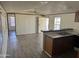 Open kitchen with a breakfast bar, wood cabinets, and grey laminate floors at 2701 E Allred Ave # 110, Mesa, AZ 85204