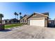 House exterior showcasing a two-car garage and artificial turf lawn at 2716 N 88Th Ln, Phoenix, AZ 85037