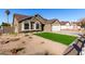 Landscaped front yard with artificial turf and drought-tolerant plants at 2716 N 88Th Ln, Phoenix, AZ 85037