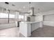 Modern kitchen featuring white cabinets, quartz countertops, and a large island at 2716 N 88Th Ln, Phoenix, AZ 85037