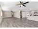 Open concept living room with grey laminate flooring and ceiling fans at 2870 W Manzanita St, Apache Junction, AZ 85120