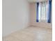 Bright bedroom featuring tile floors and window with curtains at 3015 W Paraiso Dr, Eloy, AZ 85131