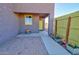 Front entrance with a paved patio, potted plants, and a yellow door at 3015 W Paraiso Dr, Eloy, AZ 85131