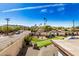 View of backyard, putting green, and surrounding neighborhood at 3357 E Gold Dust Ave, Phoenix, AZ 85028