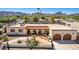 An aerial view showcasing the home's exterior, landscaping, and two-car garage at 3357 E Gold Dust Ave, Phoenix, AZ 85028