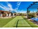 Landscaped backyard with putting green and pergola at 3357 E Gold Dust Ave, Phoenix, AZ 85028