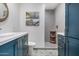 Modern bathroom with blue vanity, gray tile shower, and patterned floor tile at 3357 E Gold Dust Ave, Phoenix, AZ 85028